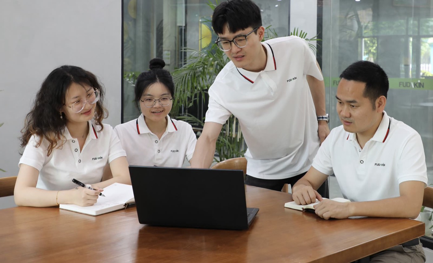Fudakin engineers reviewing a project around a table